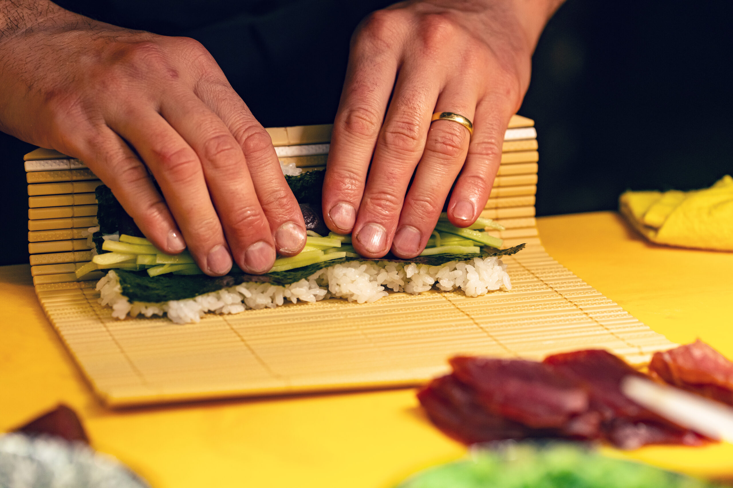 Chef hands preparing japanese food, chef making sushi, preparing sushi roll nice touch